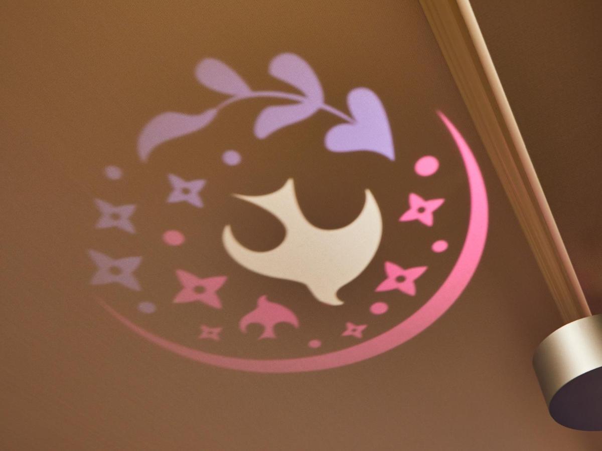 Grand Nikko Tokyo Bay Maihama Otel Urayasu Dış mekan fotoğraf The image shows a projection on a surface, featuring a circular design with a mix of colors, primarily pink and purple. The design includes a white dove, which is likely a symbol of peace, surrounded by decorative elements such as leaves and small st